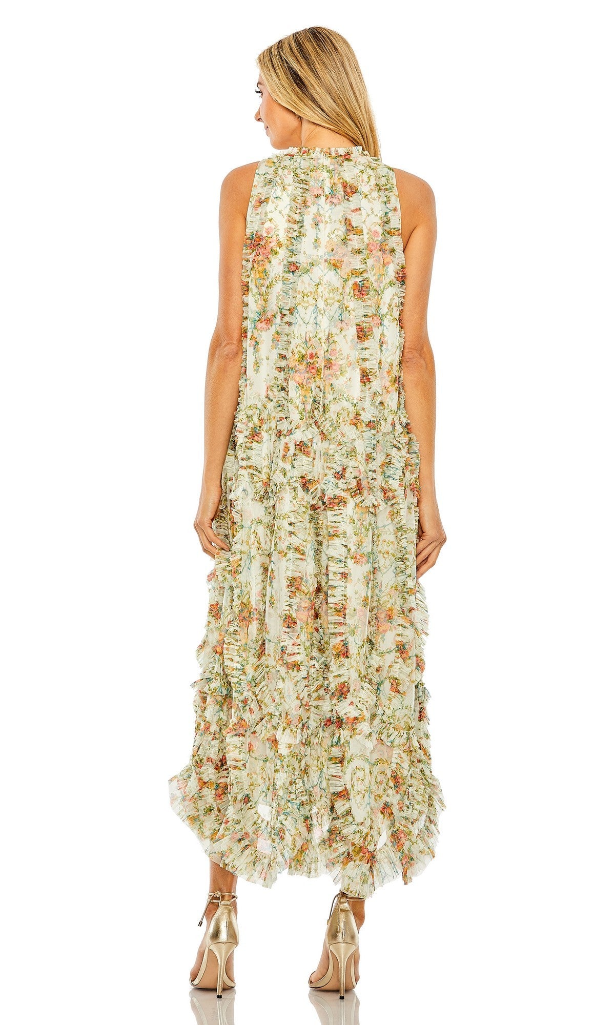 A woman stands with her back to the camera against a white background, wearing the Mac Duggal 8489 Midi Party Dress—a sleeveless floral design with micro ruffle detailing—paired with gold high-heeled sandals.